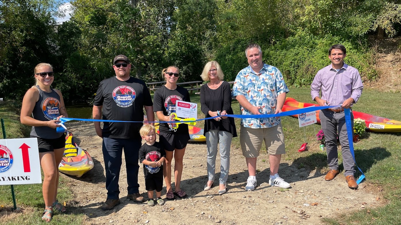Group of people posing at ribbon cutting for Cuyahoga Valley Adventures