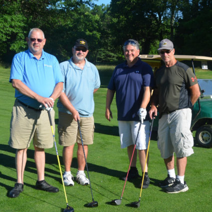 Group posing on golf course